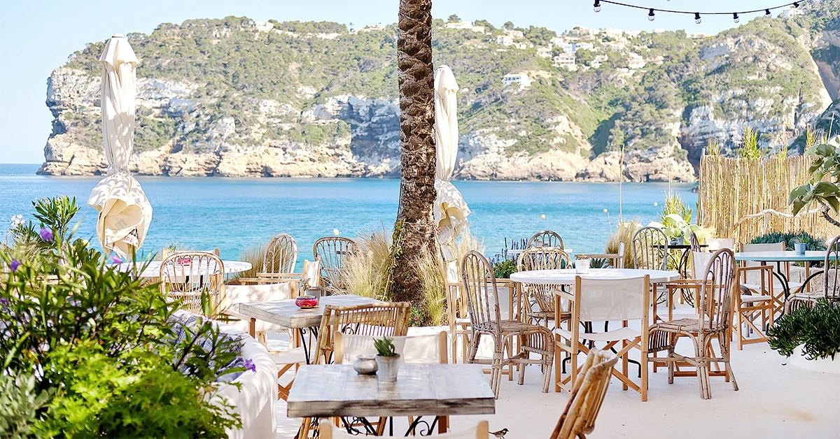 Tables and chairs on the patio overlooking the sea