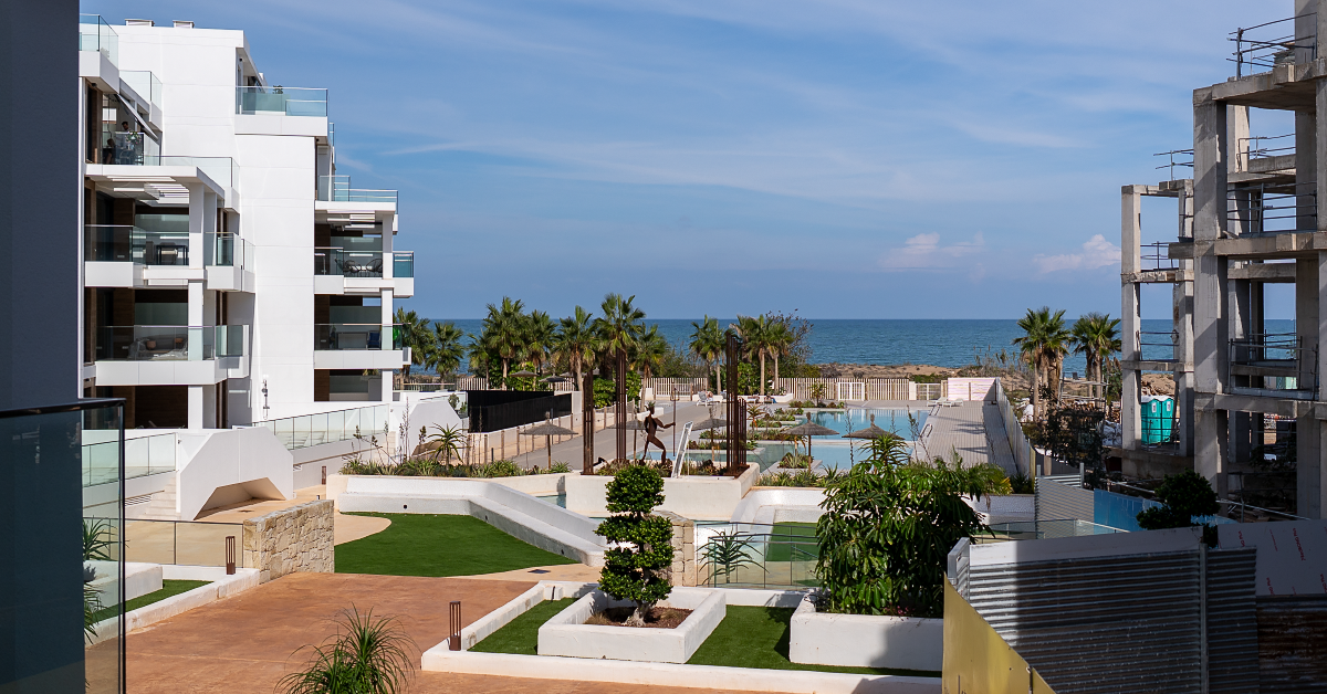 block with a green communal area and a swimming pool overlooking the sea