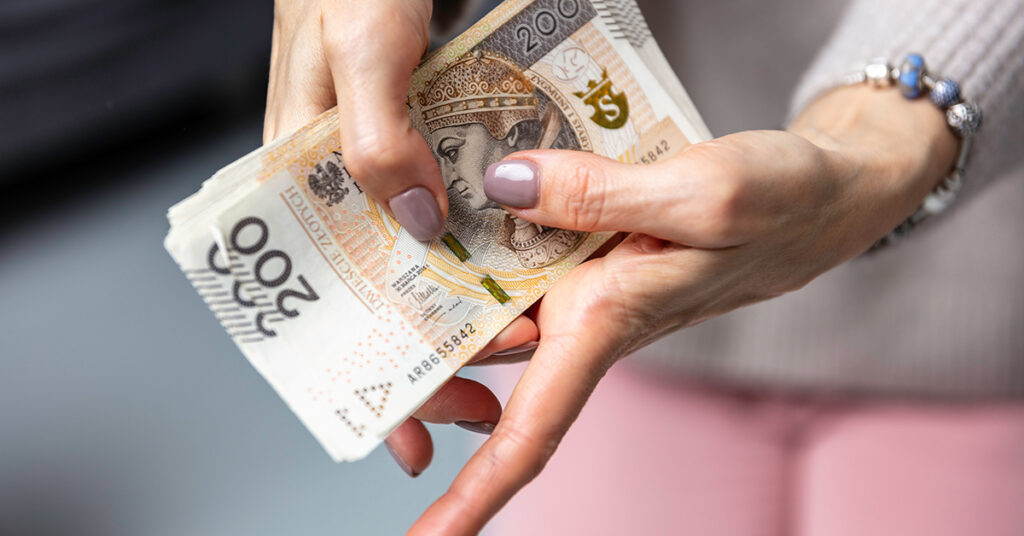 A woman is holding money in her hands.