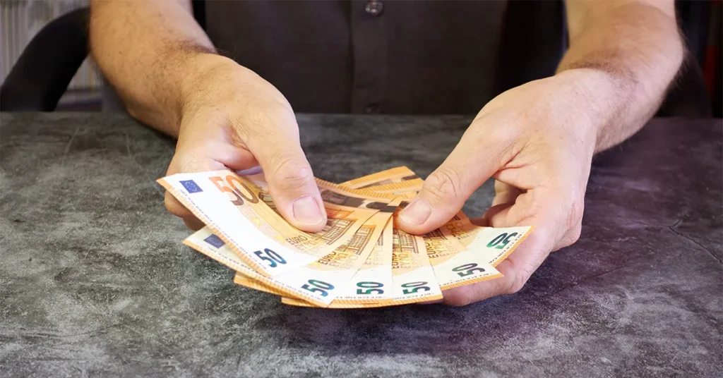 A man holds money in his hands.