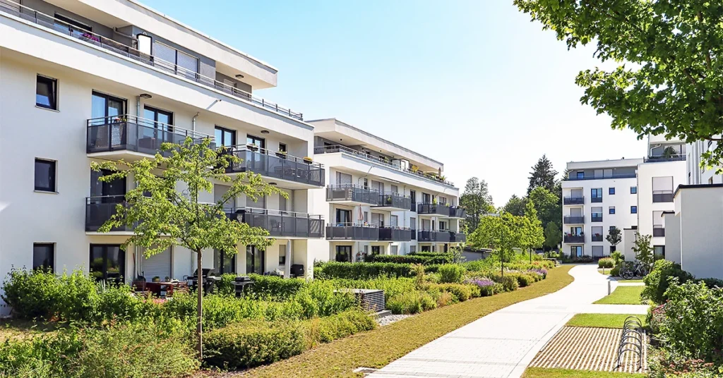 A housing estate with apartment blocks and green areas