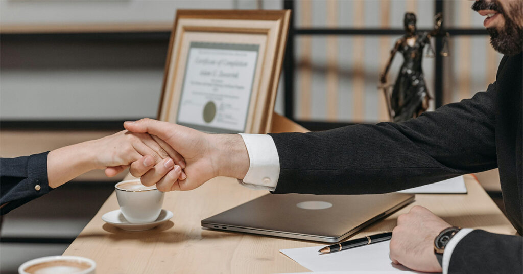 The representative and the client shake hands as a sign of fruitful cooperation.